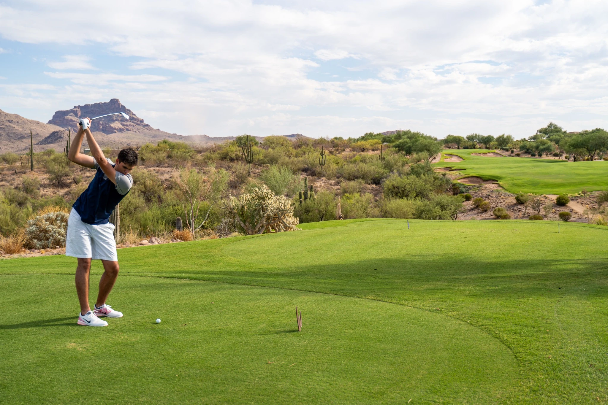 Kenan of East Coast Golf Media standing on a golf course