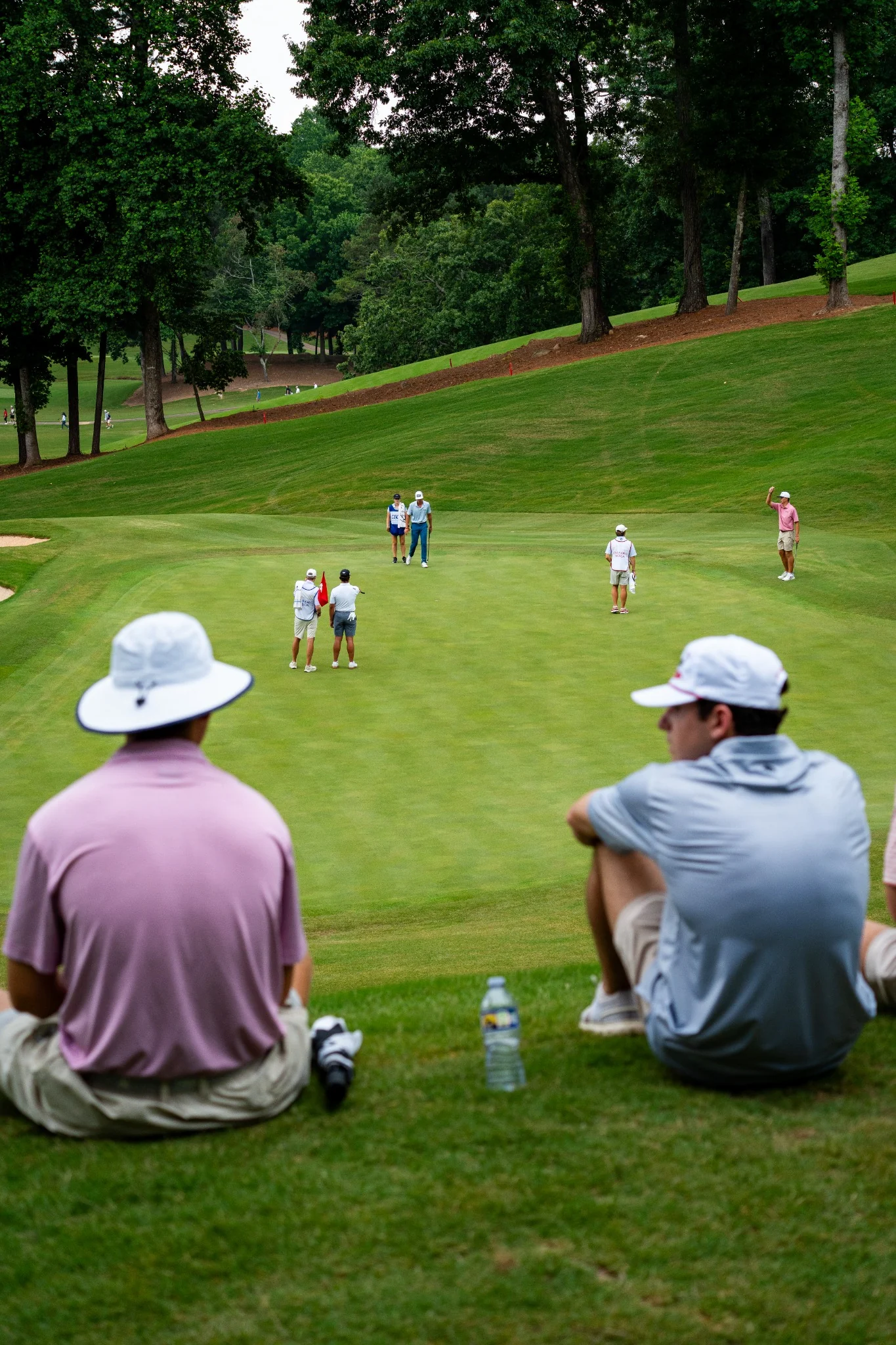Spectators and golfers on a green at Hawks Ridge Golf Club